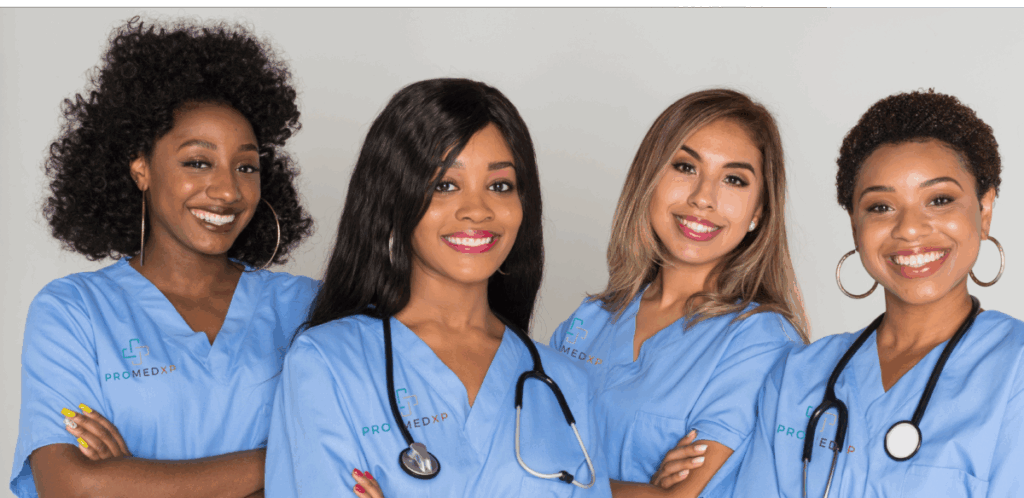 Four medical workers wearing blue scrubs.